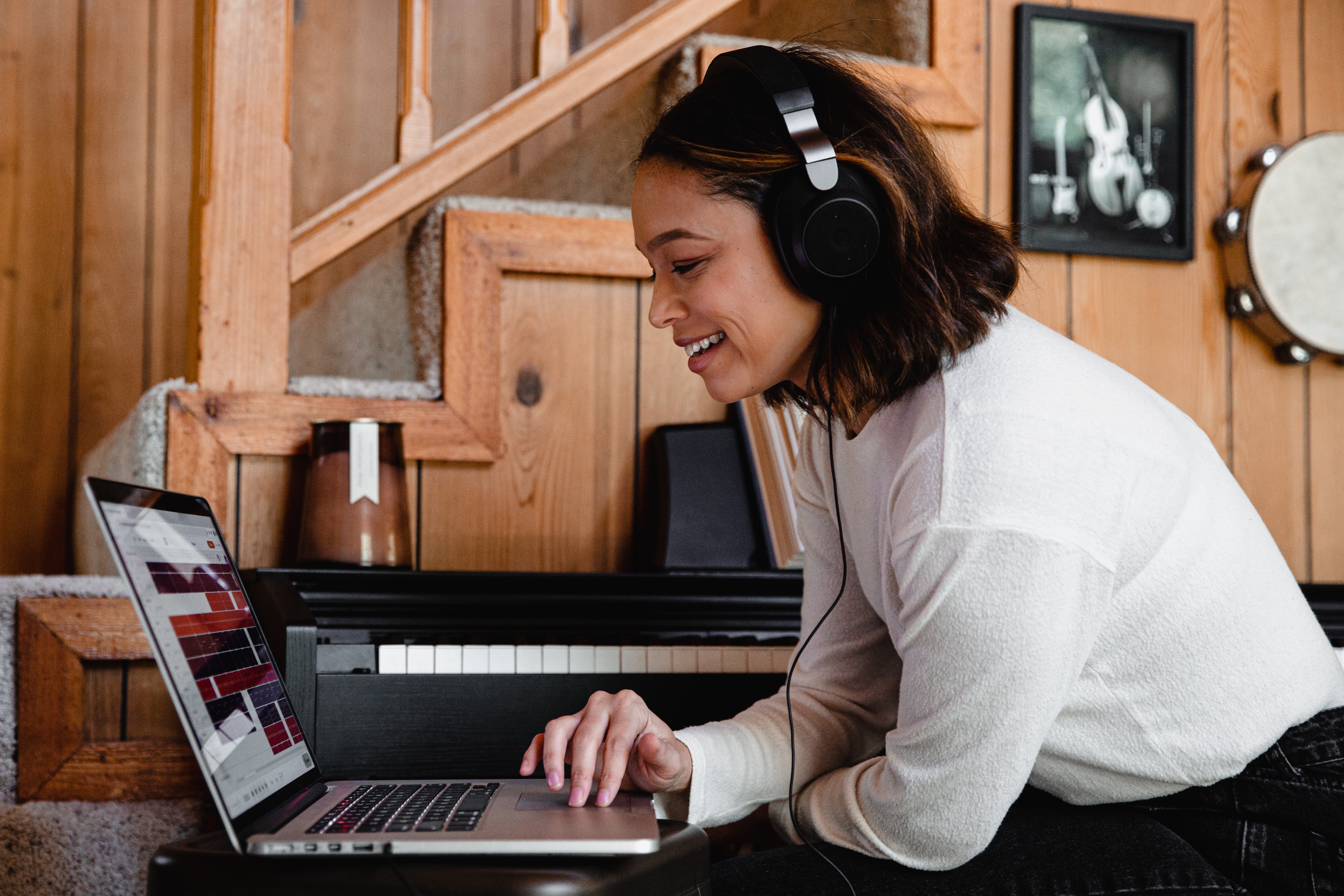 Woman with Headphones listening to a podcast while she works on a laptop